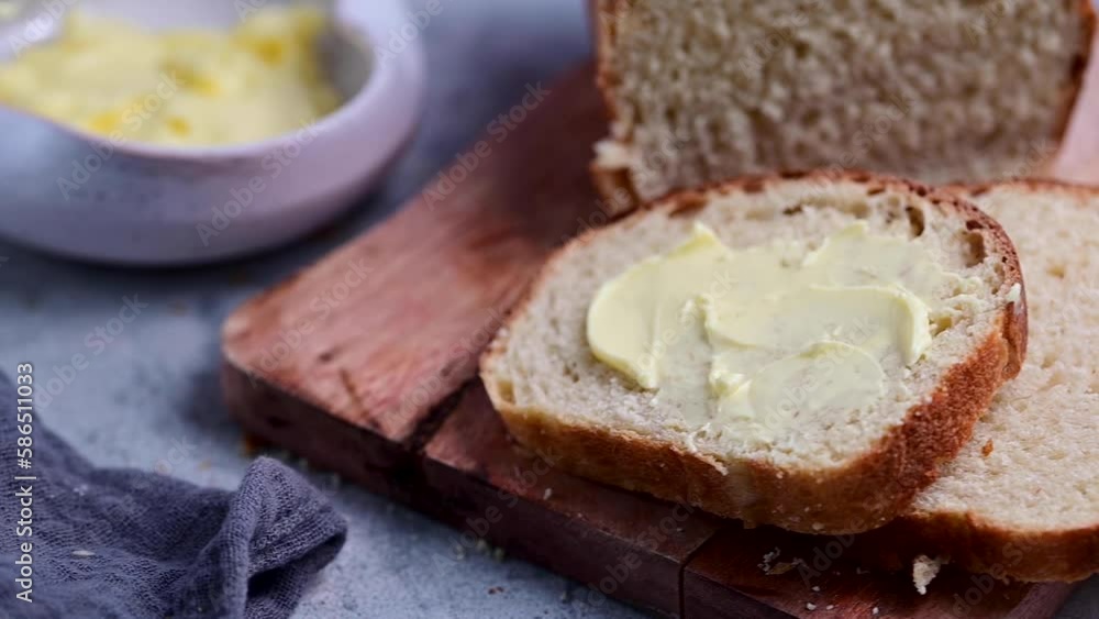 Bread and butter. Closeup sourdough slice of homemade white loaf bread with butter. Bread and butter. Closeup sourdough slice of homemade white loaf bread with butter.