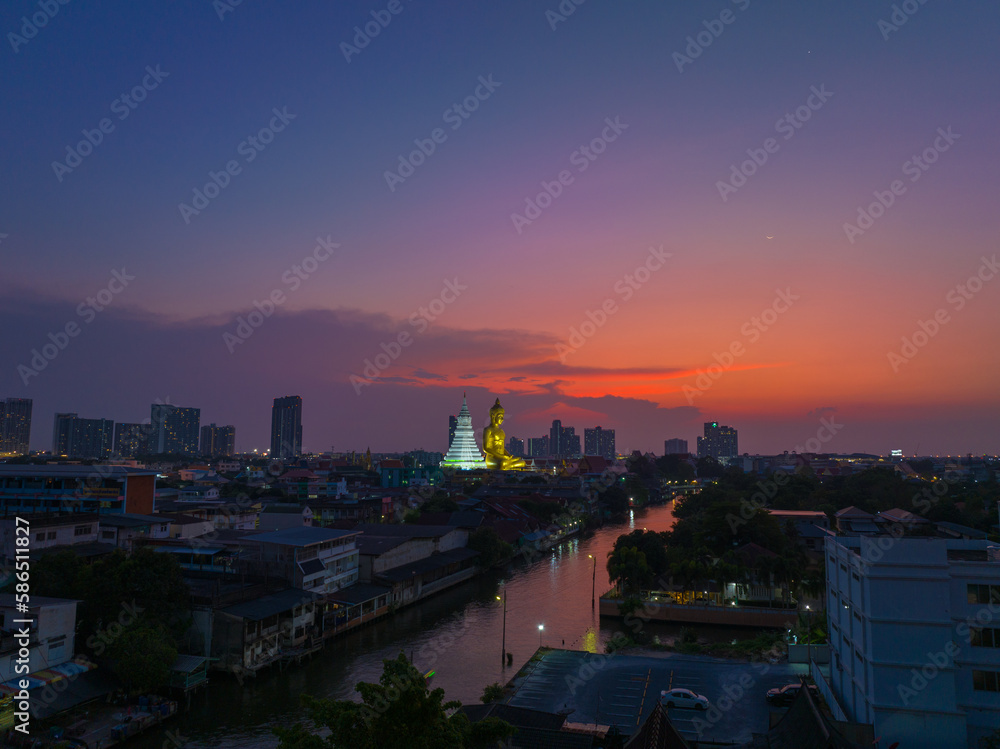 aerial view amazing sky in twilight at golden big Buddha..beautiful red cloud over bangkok city..golden big Buddha Wat Paknam Phasi Charoen famous landmarks in Bangkok Thailand.
