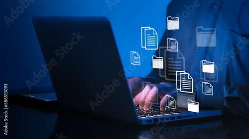 Businessman using computer to work with documents In modern computer document management system concepts Online document database and automated processes to manage files efficiently. 