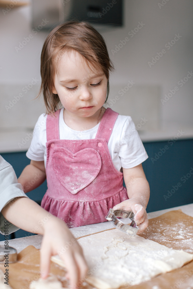 Fototapeta premium Lifestyle photo of cooking Easter decor. Family time. Under celebrated moment. Little girl making cookies. Close-up.