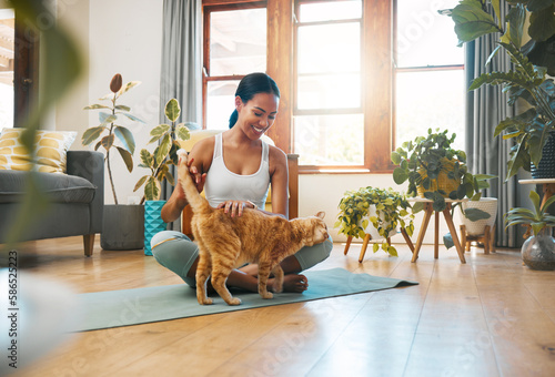 Home fitness, yoga or happy woman with cat or pet animal relaxing for wellness or healthy lifestyle. Smile, calm or active zen girl loves bonding, caring or playing with kitten or kitty in house photo
