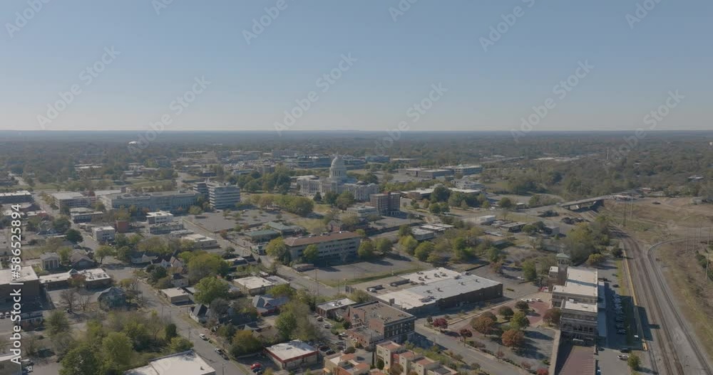 Aerial Panning Forward Shot Of Arkansas State Capitol In Residential City Against Clear Sky On Sunny Day - Little Rock, Arkansas Aerial Panning Forward Shot Of Arkansas State Capitol In Residential City Against Clear Sky On Sunny Day - Little Rock, Arkansas