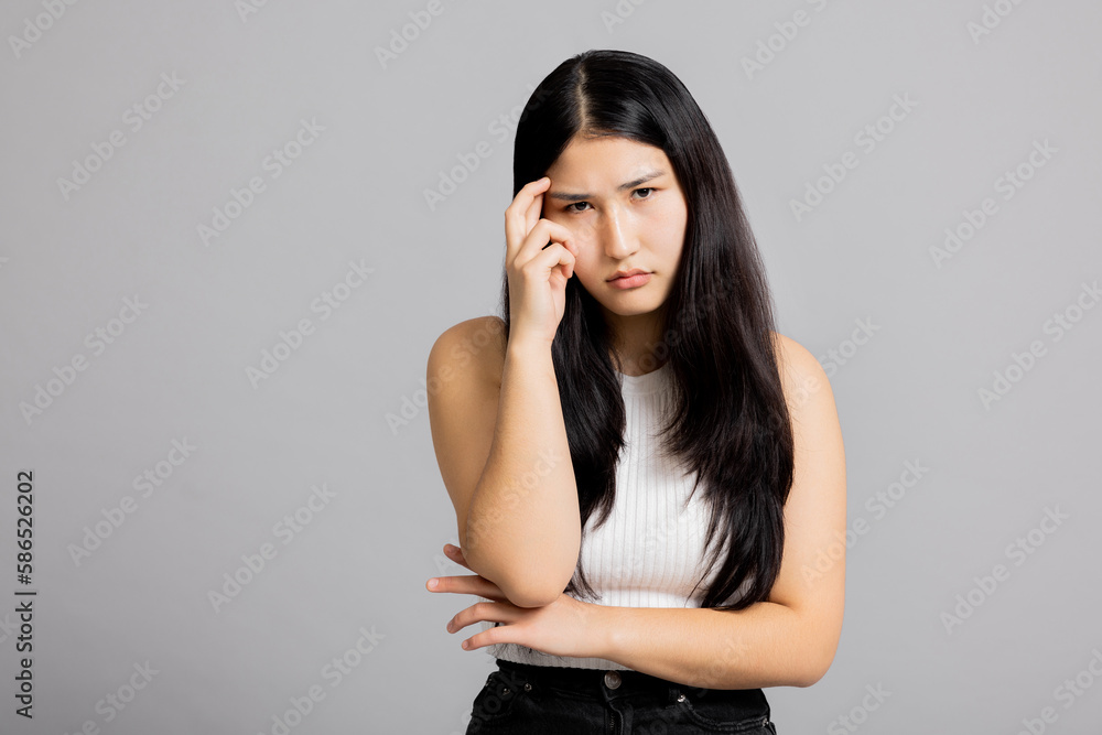 Young beautiful asian girl woman lady in white t-shirt with hand on head, headache because of stress. suffering migraine. Young beautiful asian girl woman lady in white t-shirt with hand on head, headache because of stress. suffering migraine.