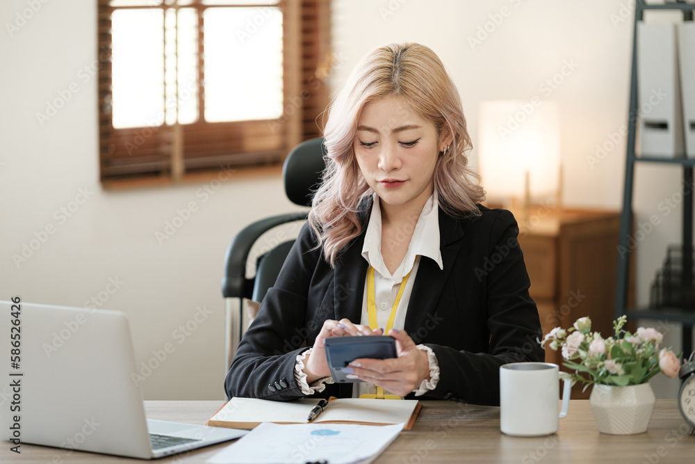Close up on laptop in office, Asian happy beautiful businesswoman in formal suit work in workplace. Attractive female employee office worker smile. Close up on laptop in office, Asian happy beautiful businesswoman in formal suit work in workplace. Attractive female employee office worker smile.