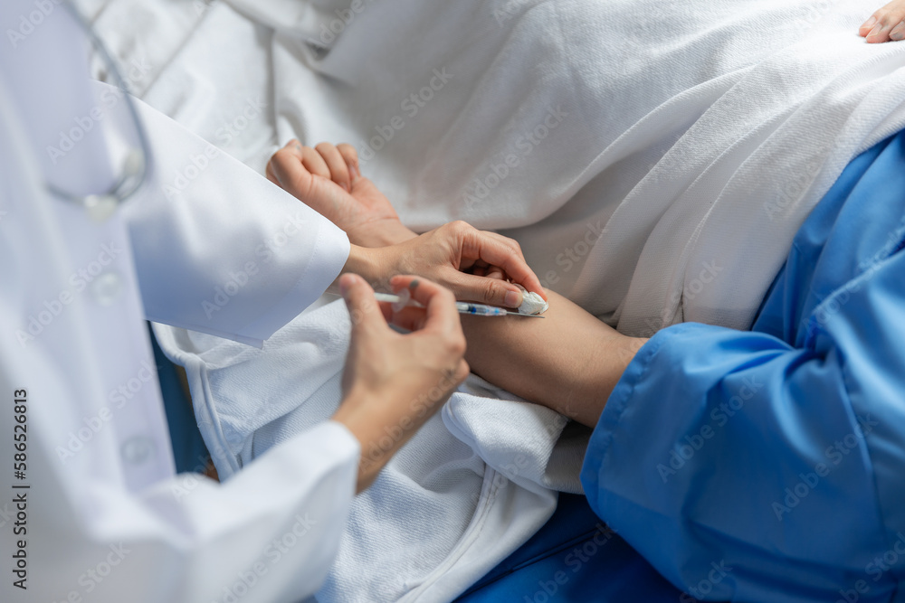 Close-up of doctor handing drops to sick male patient in hospital bed. Close-up of doctor handing drops to sick male patient in hospital bed.