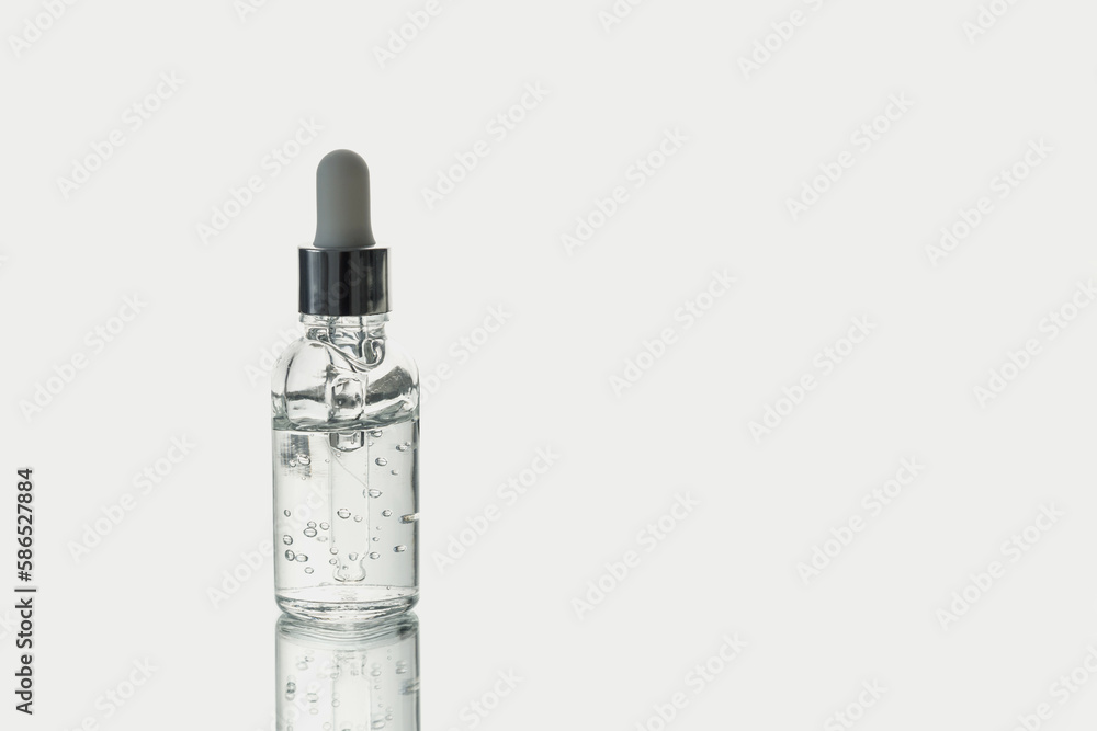 Glass dropper bottle with oxygen cosmetic gel isolated on white with backlight and reflection. Glass dropper bottle with oxygen cosmetic gel isolated on white with backlight and reflection.