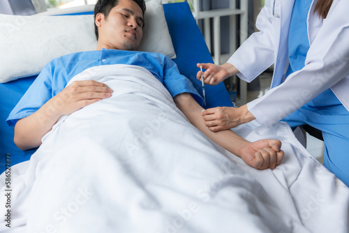 Doctor and male patient in hospital room