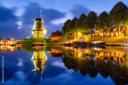 Dokkum, Netherlands. The famous windmill.  Journey through the Netherlands. Historical sites and famous places. Dutch canals with boats. photo