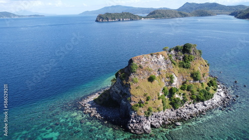 Sombrero Island. Anilao. Philippines. Small tropical island in the middle of the sea. Aerial view of an island in the ocean.