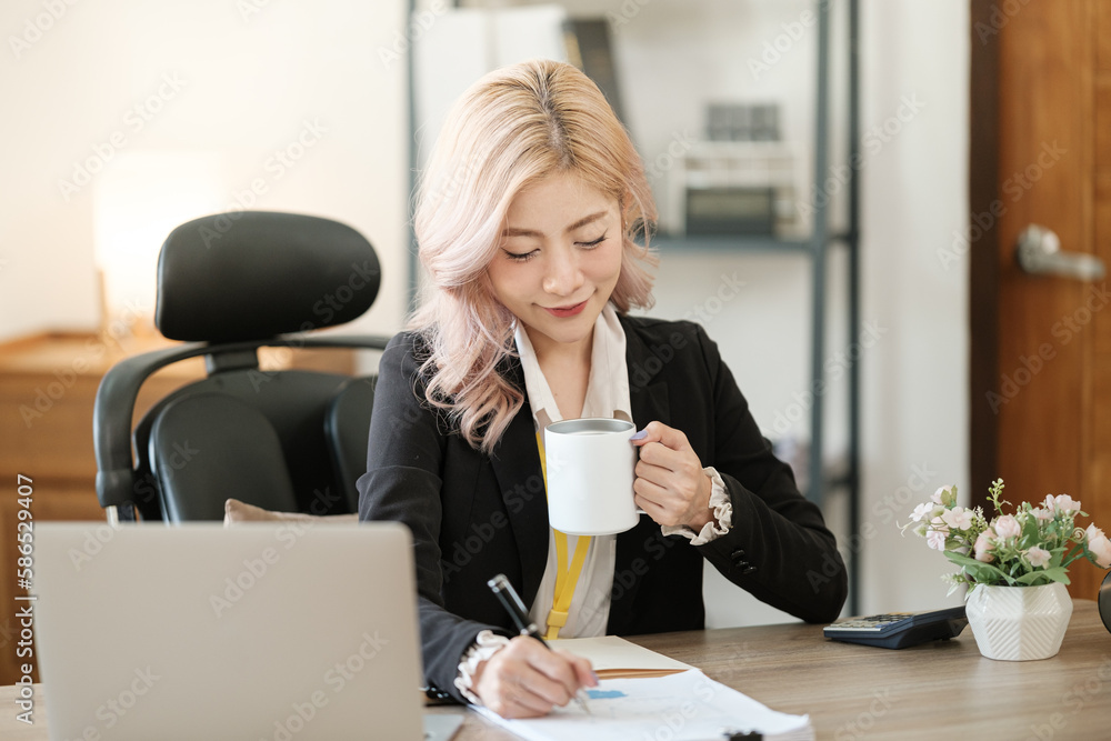 Close up on laptop in office, Asian happy beautiful businesswoman in formal suit work in workplace. Attractive female employee office worker smile. Close up on laptop in office, Asian happy beautiful businesswoman in formal suit work in workplace. Attractive female employee office worker smile.
