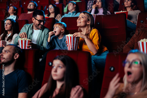 Parents with child in cinema.