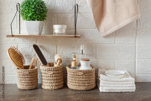 bathroom background, towels, plant and hygiene accessories on the table against the backdrop of white tiles