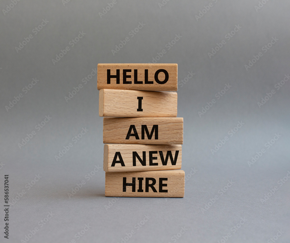 Hello I am a new hire symbol. Concept words Hello I am a new hire on wooden blocks. Beautiful grey background. Business and Hello I am a new hire concept. Copy space. Hello I am a new hire symbol. Concept words Hello I am a new hire on wooden blocks. Beautiful grey background. Business and Hello I am a new hire concept. Copy space.
