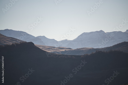 Panorama of a mountain landscape with slopes and ridges in the distance on a sunny autumn morning minimalism  tonal perspective of mountain ranges