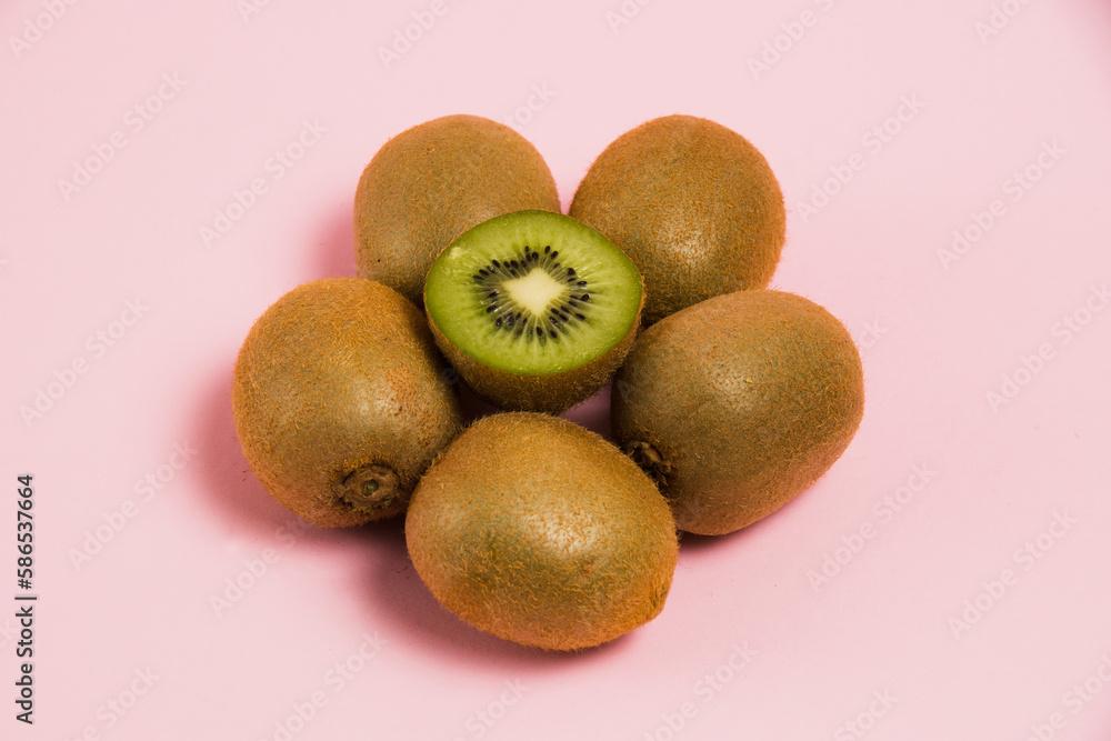Fototapeta premium Juicy kiwi on a pink background. Delicious fruit on a bright background.