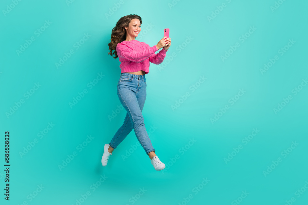 Full length photo of lovely funky girl walk go store shop video talk record live stream empty space isolated on cyan color background