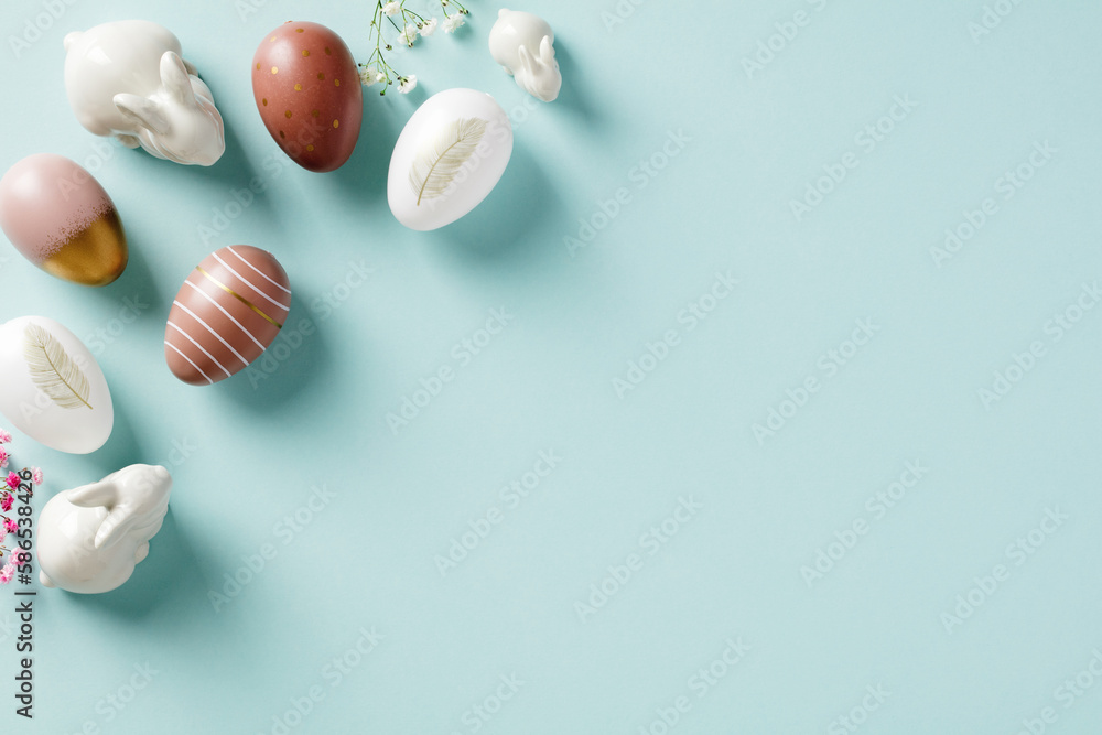 Easter eggs, decorative bunnies, flowers on pastel blue background. Easter concept. Flat lay, top view Easter eggs, decorative bunnies, flowers on pastel blue background. Easter concept. Flat lay, top view