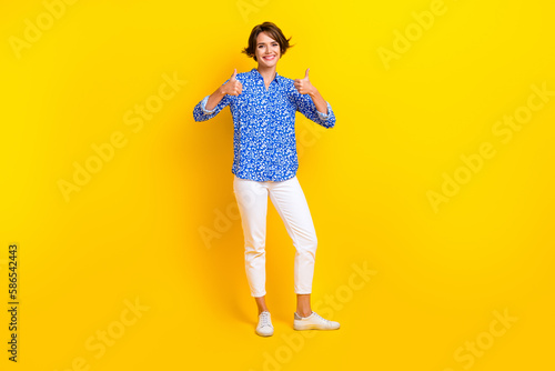 Full length photo of confident pretty lady wear print shirt showing two thumbs up isolated yellow color background