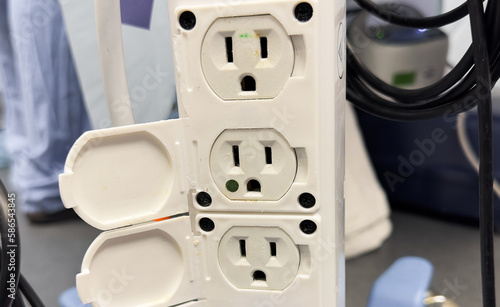 Close-up shot of an electric plug outlet installed in a white wall