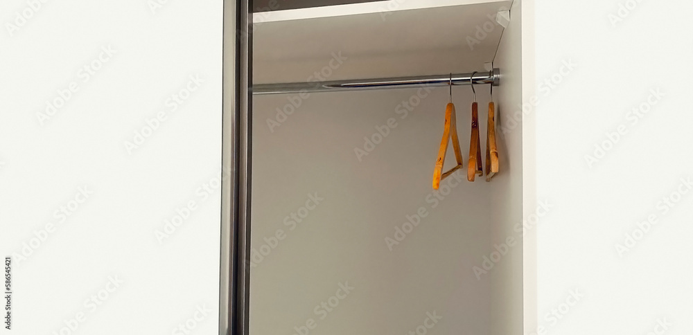 White empty wardrobe closet with hangers in the room White empty wardrobe closet with hangers in the room