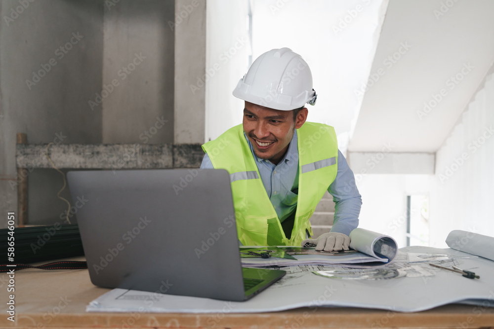 Architect or Engineer working with blueprints for architectural plan, engineer sketching a construction project, green energy concept Architect or Engineer working with blueprints for architectural plan, engineer sketching a construction project, green energy concept