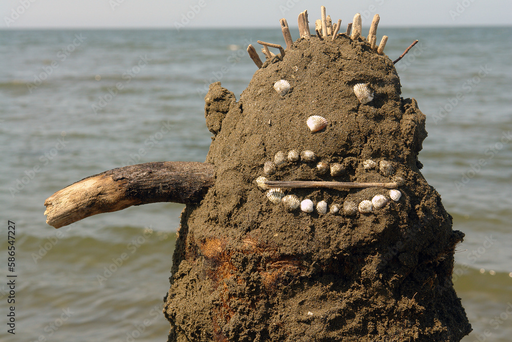 Monster sculpture made of sands, shells and woods. Created by a child.