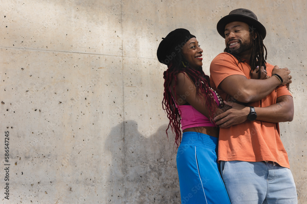 Portrait of African-American couple embracing each other..