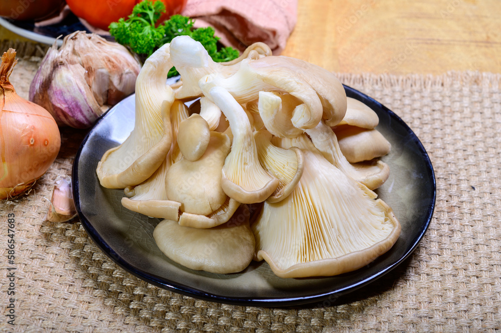 Tasty vegetarian food, fresh organic Pleurotus ostreatus, or oyster mushrooms, hiratake, or pearl oyster mushrooms Tasty vegetarian food, fresh organic Pleurotus ostreatus, or oyster mushrooms, hiratake, or pearl oyster mushrooms