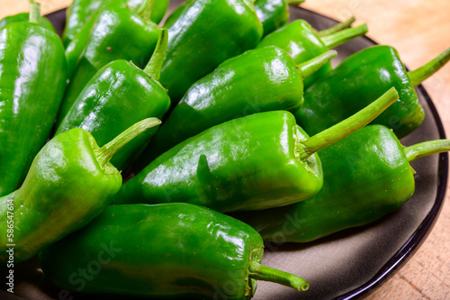 Fresh green mild padron pepper pementos, ready for grill or to be fried with olive oil, traditional snack in Galicia, Spain photo