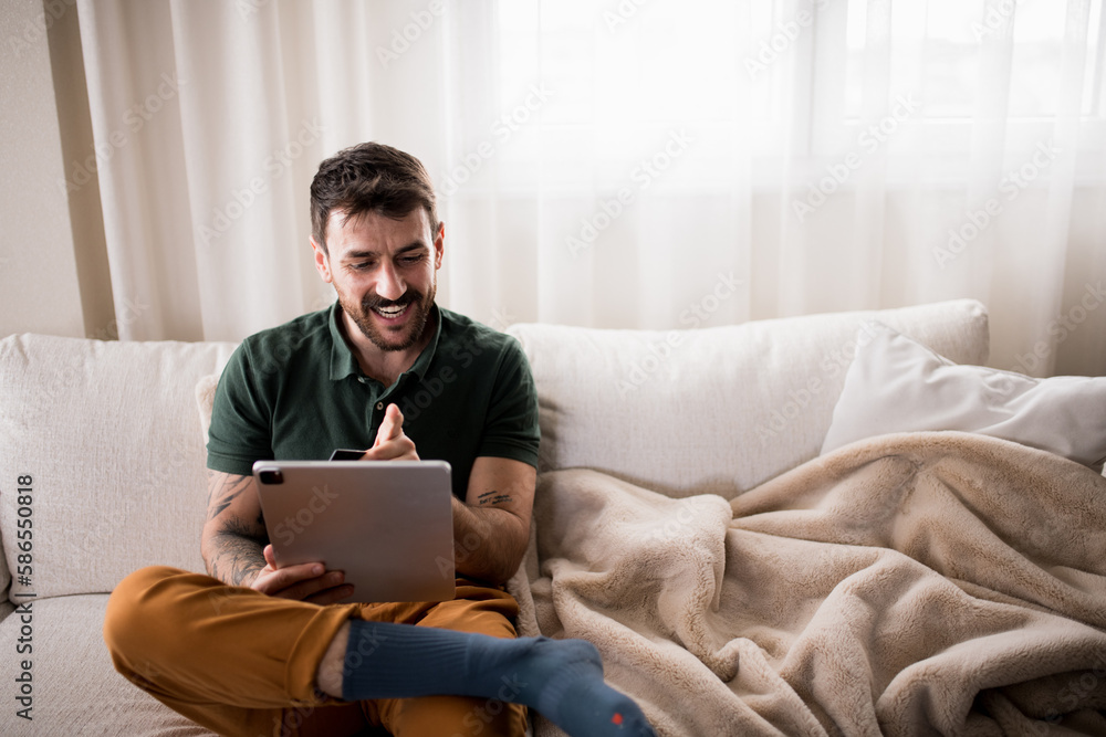 Handsome young freelancer working from home on his laptop. Handsome young freelancer working from home on his laptop.