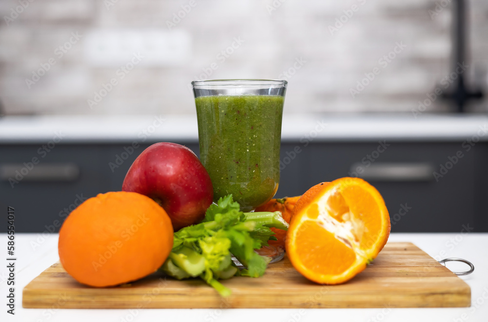 healthy smoothie in glass and fruits all around on wooden board kitchen table and background.slim fit weight loss take natural vitamins.bio tangerine celery spinach kiwi and apple.mashed fruits healthy smoothie in glass and fruits all around on wooden board kitchen table and background.slim fit weight loss take natural vitamins.bio tangerine celery spinach kiwi and apple.mashed fruits