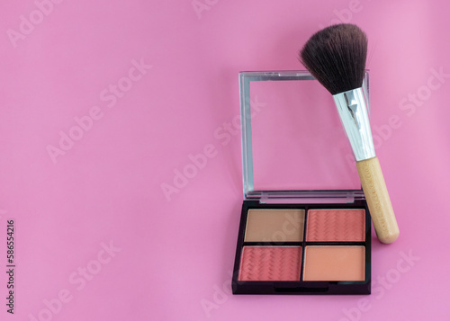 blush with four colors isolated white pink background or dark red textile material.woman hand holding brush high quality product photography