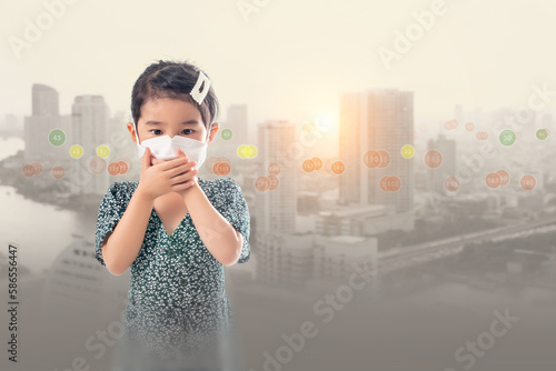 Young Asian girl wearing a mask to prevent pm.2.5 dust on a bad weather city background.