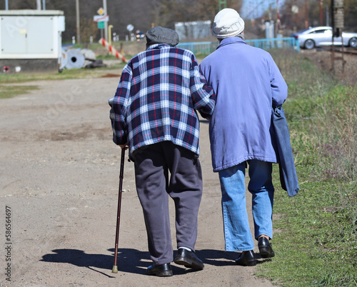Senior couple walk on the dirt road © majorosl66