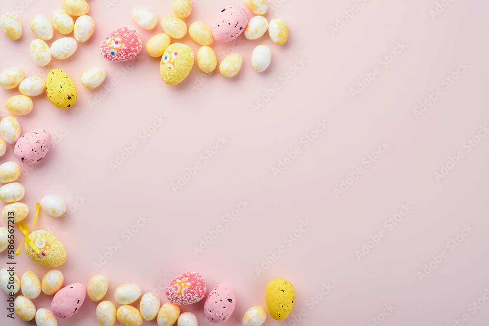 Happy Easter. Easter eggs and white rabbit decoration isolated on trendy pastel pink background with white and yellow roses. Spring Happy Easter holiday card and mock up background. Top view flat lay. Happy Easter. Easter eggs and white rabbit decoration isolated on trendy pastel pink background with white and yellow roses. Spring Happy Easter holiday card and mock up background. Top view flat lay.