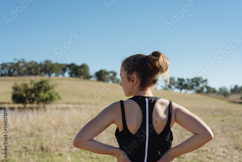 behind view of teen girl going for a morning jog photo