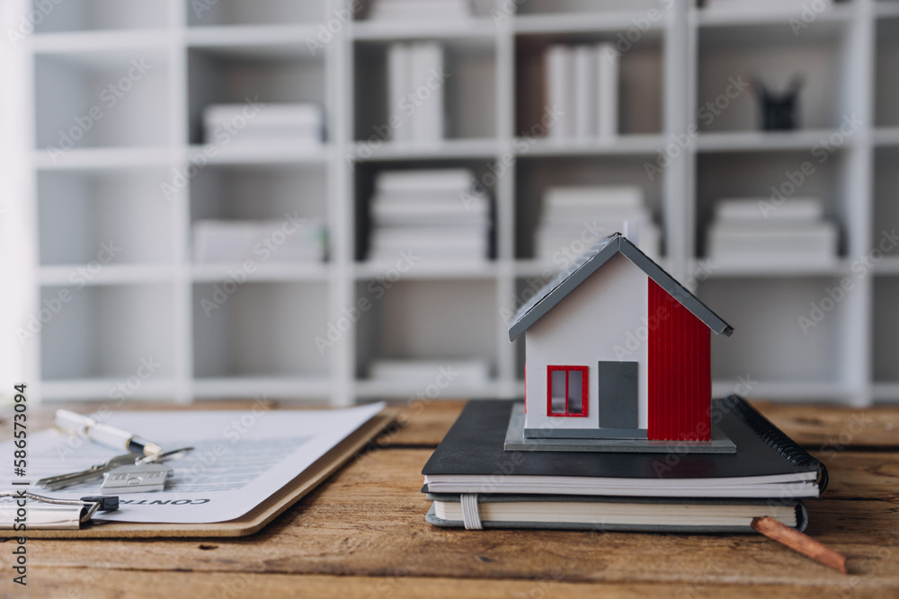 Home buyers meet and negotiate with real estate agents about renting or buying a home in the office. Home buyers meet and negotiate with real estate agents about renting or buying a home in the office.