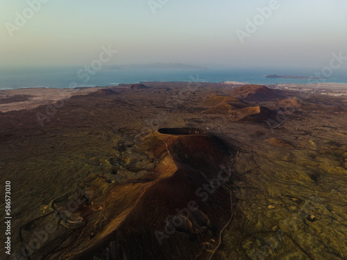 Obraz na płótnie View from above, stunning aerial view of Calderon Hondo during a beautiful sunrise. Calderon Hondo is a volcanic caldera in the sland of Fuerteventura, Canary Islands. w salonie
