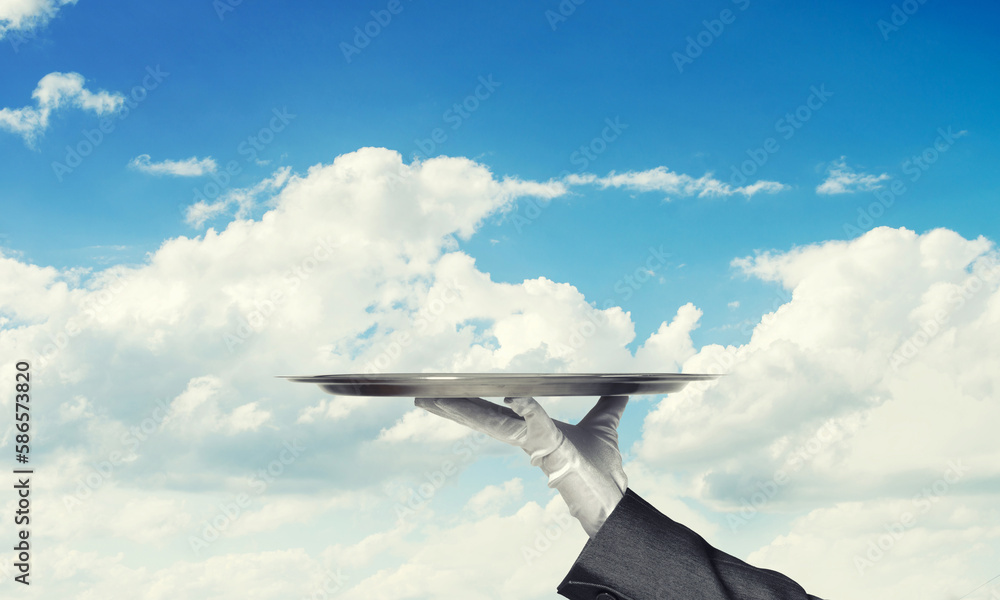 Waiter holding empty silver platter ready for product or item placement