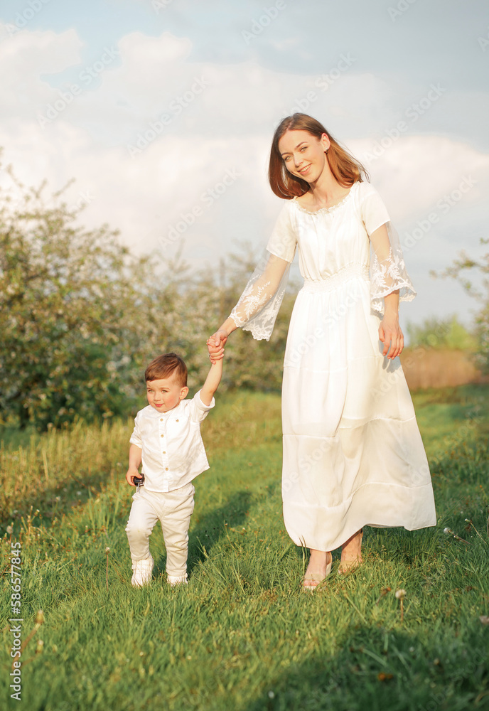 Fototapeta premium Portrait of happy mother and her baby boy. Beautiful touching scene of mom and son.
