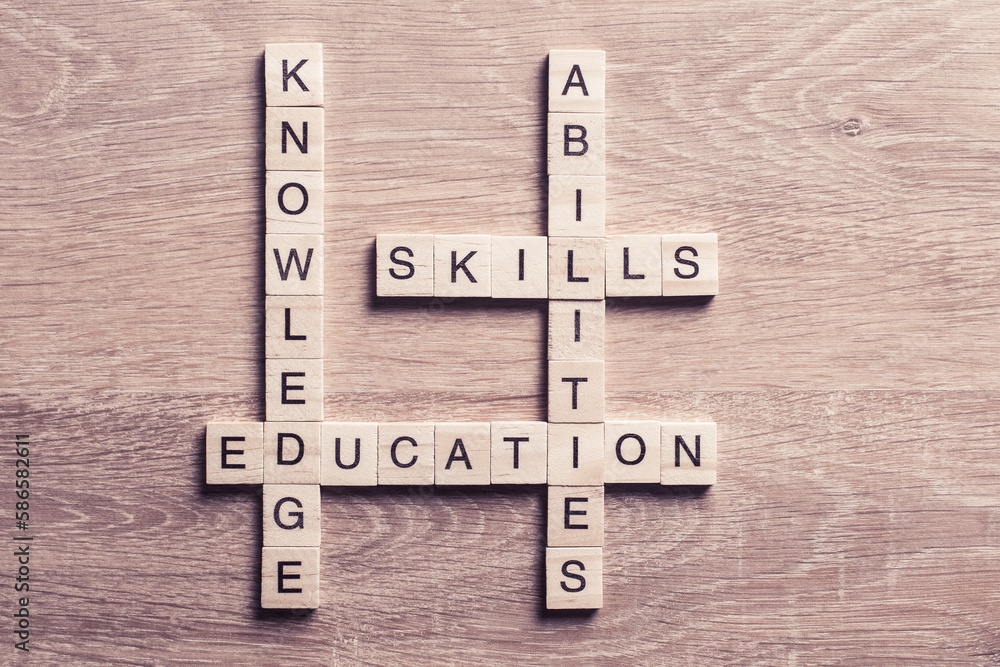 Conceptual keywords on wooden table with elements of game making crossword Conceptual keywords on wooden table with elements of game making crossword