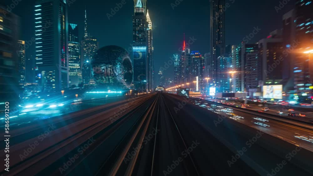 Motion timelapse view of journey on the modern driverless Dubai elevated Rail Metro System running alongside the Sheikh Zayed Road at night in Dubai, United Arab Emirates (UAE).