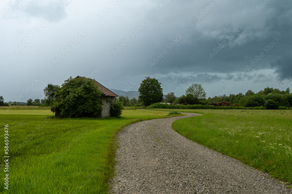 rural road in the countryside and thunderclouds