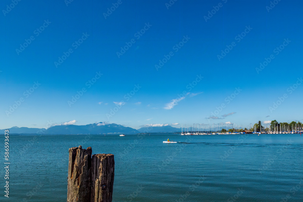 beautiful view of the lake chiemsee with the alps in background and sail boats