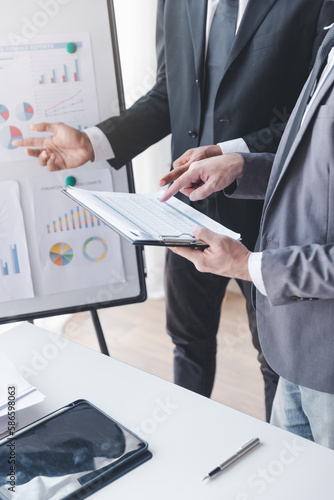 Finance and investment concept, Businessman present business finance investment plan with his partner, Investor colleagues discussing new investment plan by financial graph data on office table