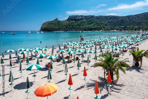Poetto beach, crystal clear water and the famous Sella del Diavolo, Cagliari, Sardinia, Italy