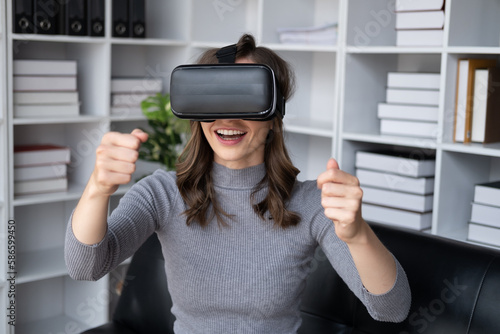 Beautiful woman in virtual reality glasses having fun at home.