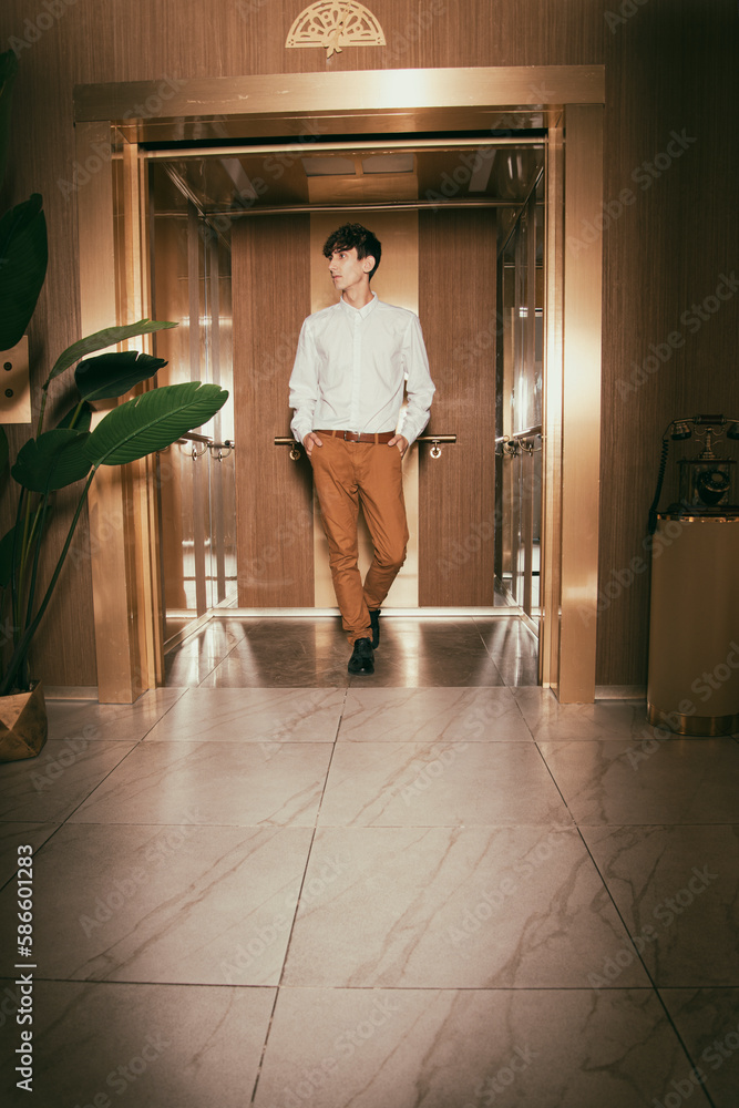 A smartly dressed man in a hotel elevator. Head going up to the office. Business center. A smartly dressed man in a hotel elevator. Head going up to the office. Business center.