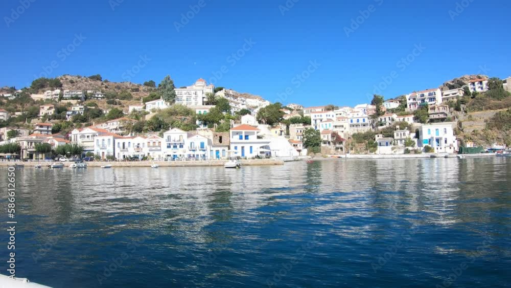 Boats floagting on clear blue water of the Mediterranean sea in Evdilos, a typical traditional Greek town on the sea in Ikaria island Boats floagting on clear blue water of the Mediterranean sea in Evdilos, a typical traditional Greek town on the sea in Ikaria island