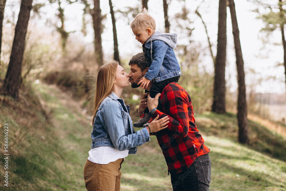 Young family with little son in forest Young family with little son in forest
